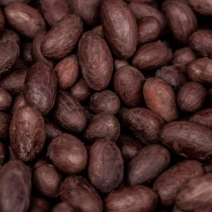 A detailed close-up of raw cocoa beans from Nigeria, showcasing their natural texture and rich color.