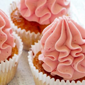 Tasty cupcakes with pink frosting, perfect for a sweet treat or dessert celebration.